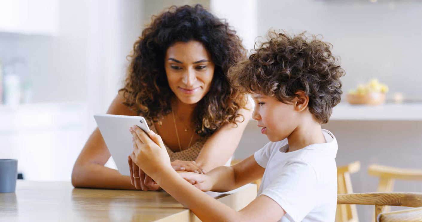 Speech and language pathologist assisting a child in a communication skills assessment 