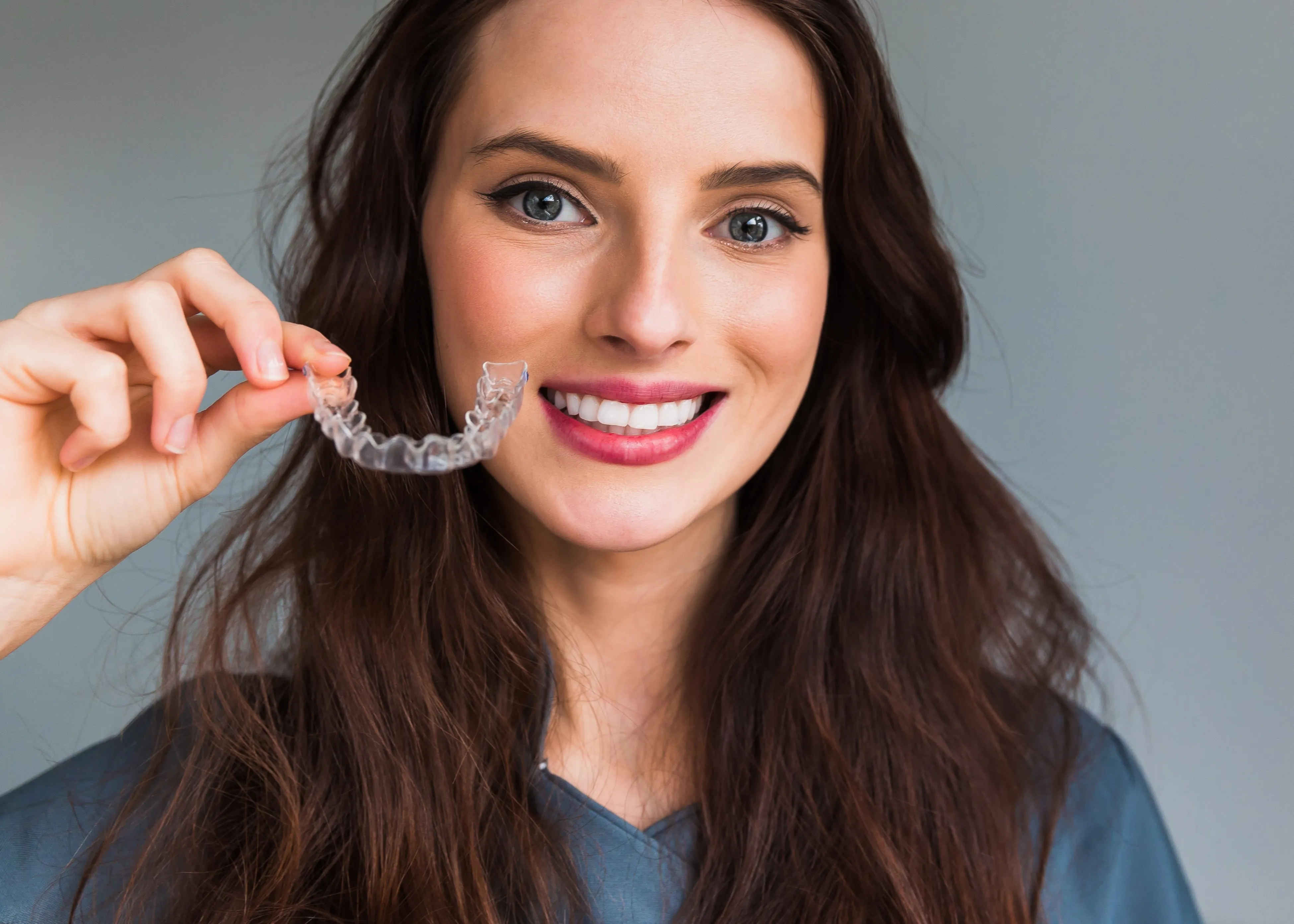A woman using clear aligners