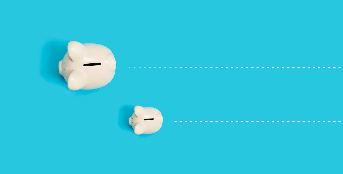 Perspective is looking down on a large white piggy bank next to a smaller white piggy bank against a blue background with white dotted lines trailing each piggy bank