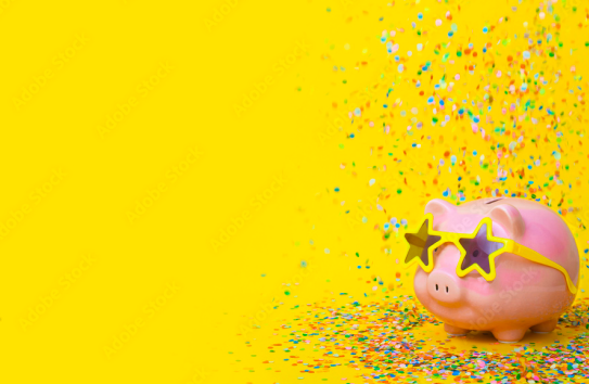 White piggy bank with sunglasses on against a yellow background with confetti. 