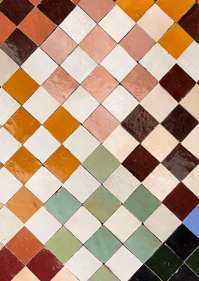 Diagonal pattern of colorful square ceramic tiles in shades of brown, orange, cream, green, and blue.