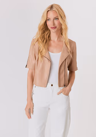 Blonde woman wearing a cream-colored open-knit sweater with long sleeves and a round neckline.