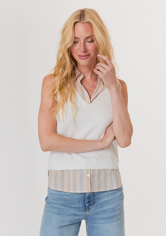 Blonde woman wearing a cream-colored open-knit sweater with long sleeves and a round neckline.