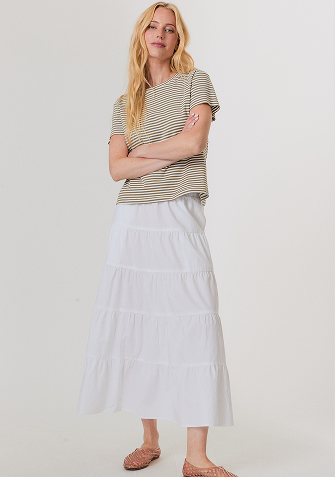 Blonde woman wearing a cream-colored cable knit sweater with a half-zip collar.