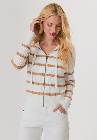 Woman wearing a black mesh sweater and a black leather midi skirt with studded high heel sandals.