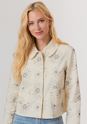 Woman wearing a black mesh sweater and a black leather midi skirt with studded high heel sandals.