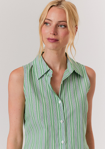 Blonde woman wearing a cream-colored cable knit sweater with a half-zip collar.