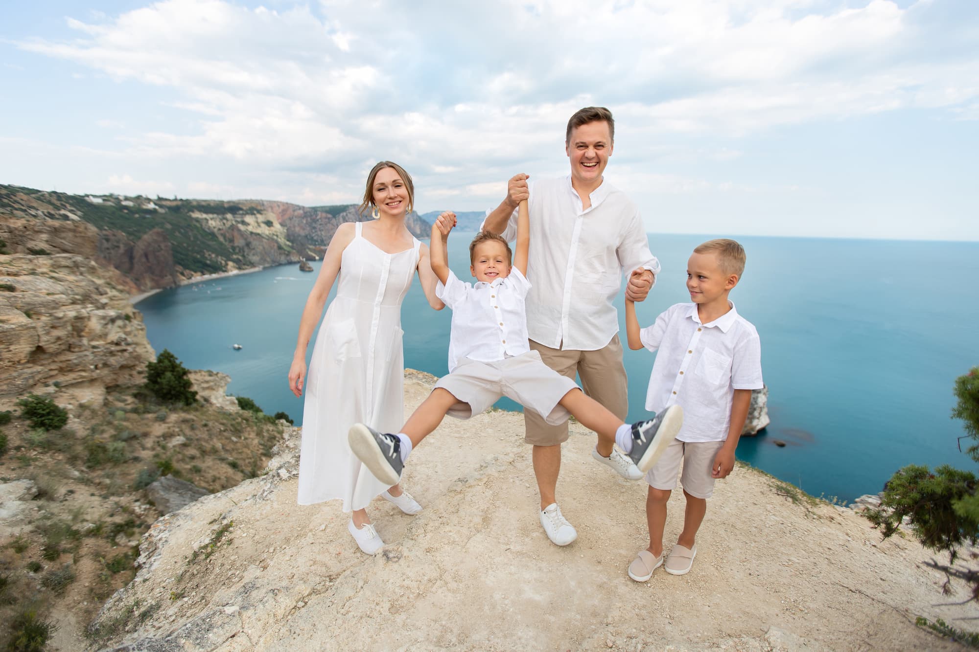 happy family having fun on top of view point on beach