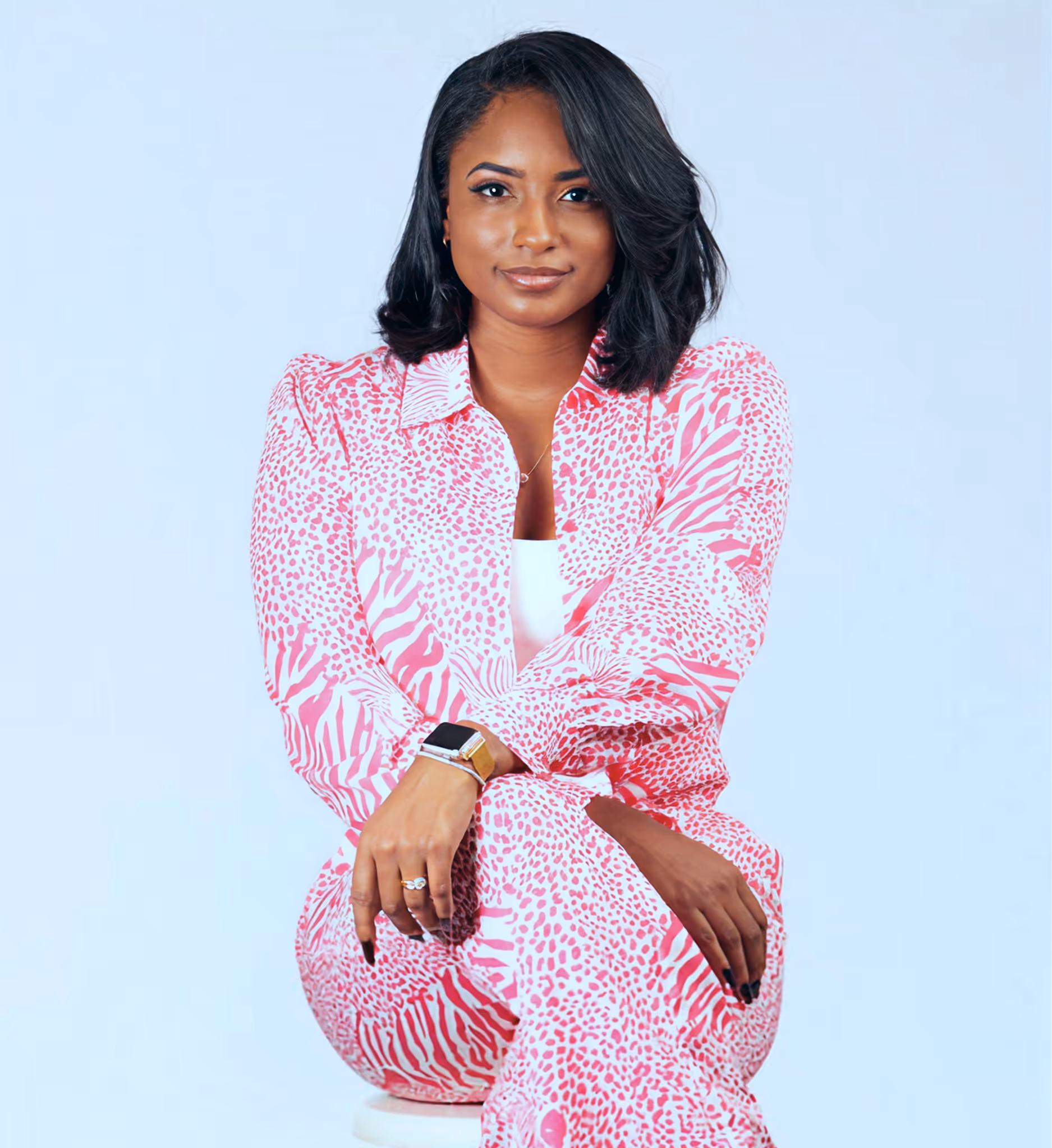 Female owner of Galore Business Management elegantly sitting looking in the camera confidently.