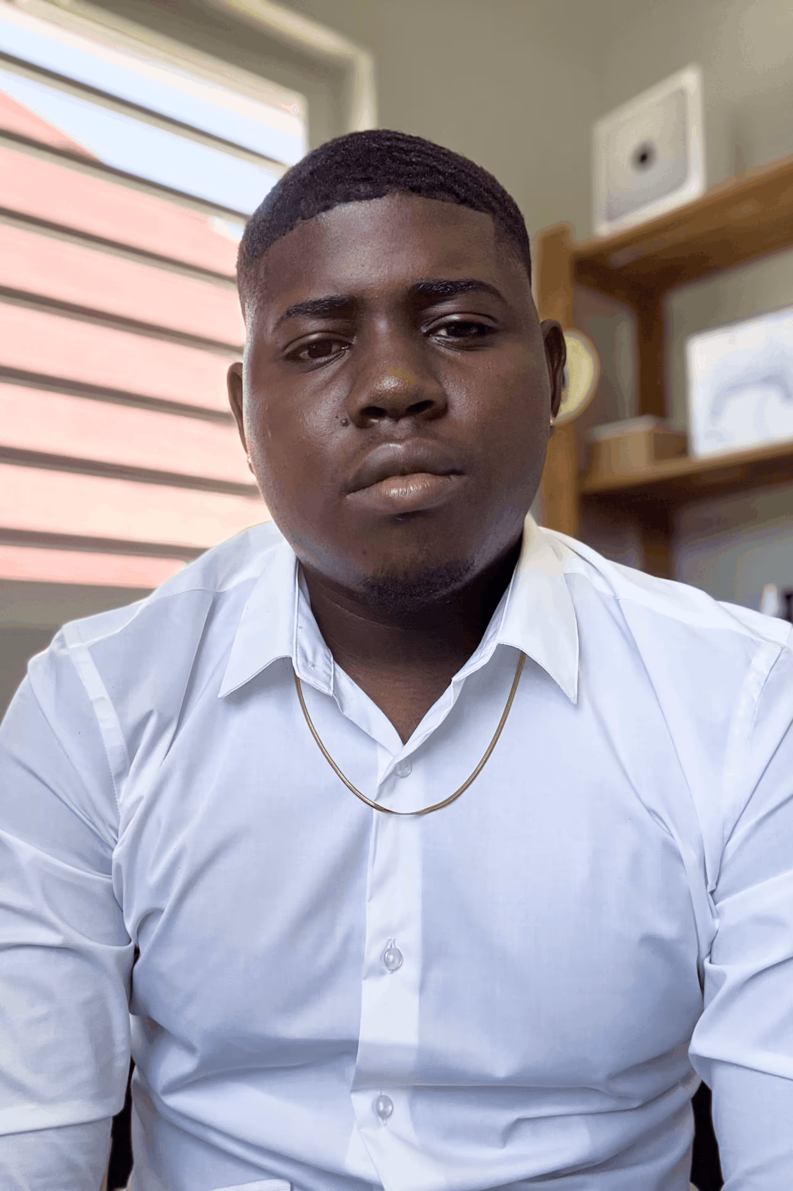 Image of Serious Smiles Owner sitting looking directly in the camera inviting personal relationaship.