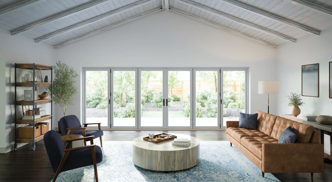 Wide, white-framed multi-panel patio doors spanning the living room wall, allowing abundant natural light and providing seamless access to the backyard and garden views.