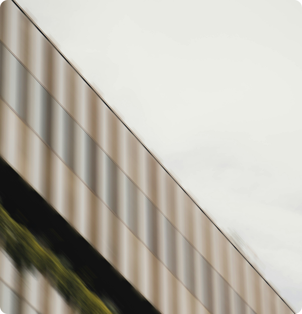 An image of a fence in motion as viewed from a train.