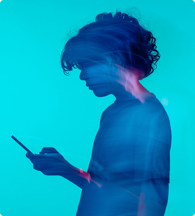 Artistic True Detective Season 1-style image of motion and lights clipped into the image of a young man on his phone.