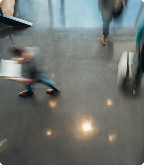 Blurry image of people walking through an airport.