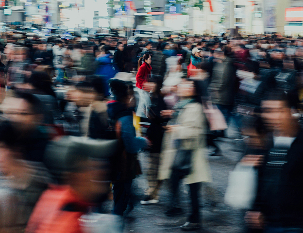 Crowded and blurred image of a street in a busy city.