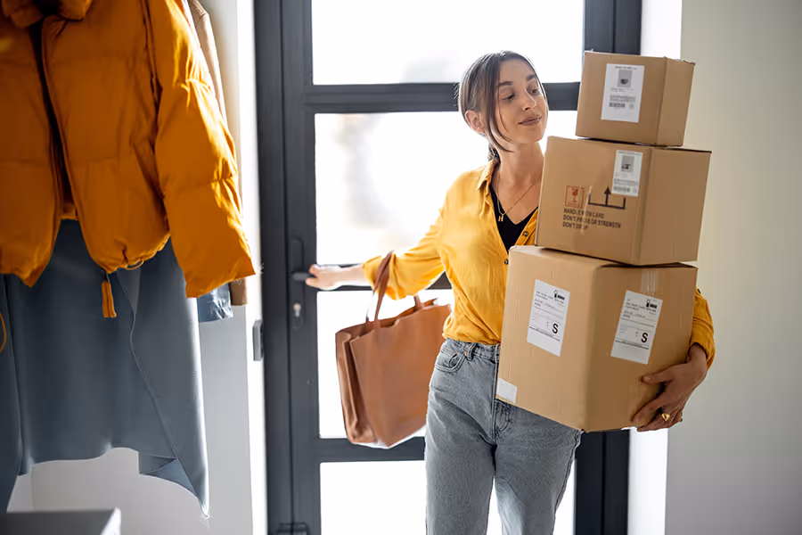 A woman bringing in her packages from outside