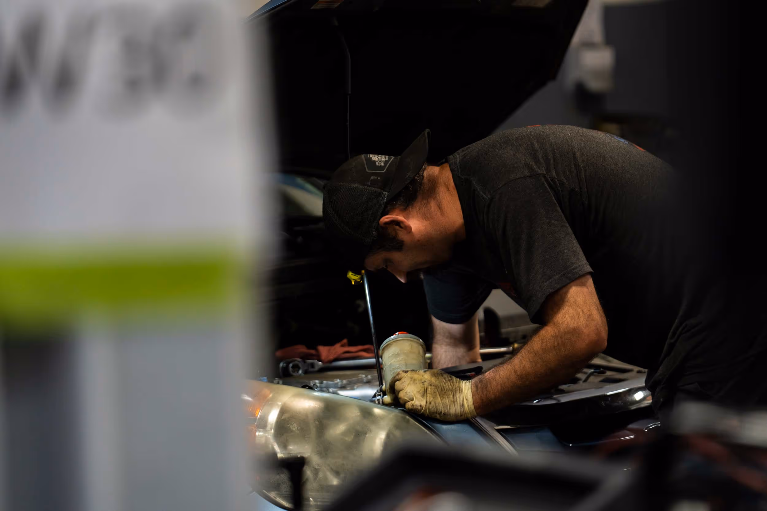 Auto technician doing oil change