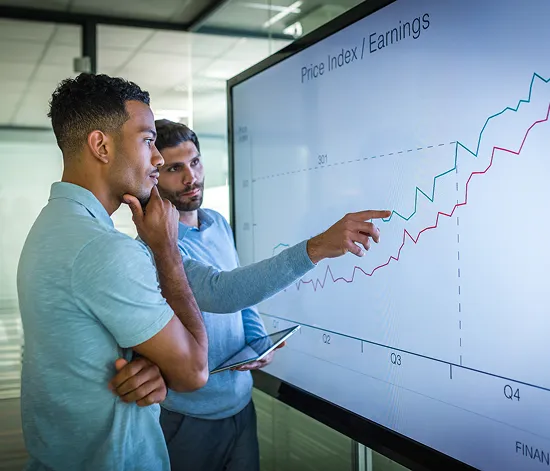 Professional accountants analyzing financial growth charts and developing strategic business plans in modern office