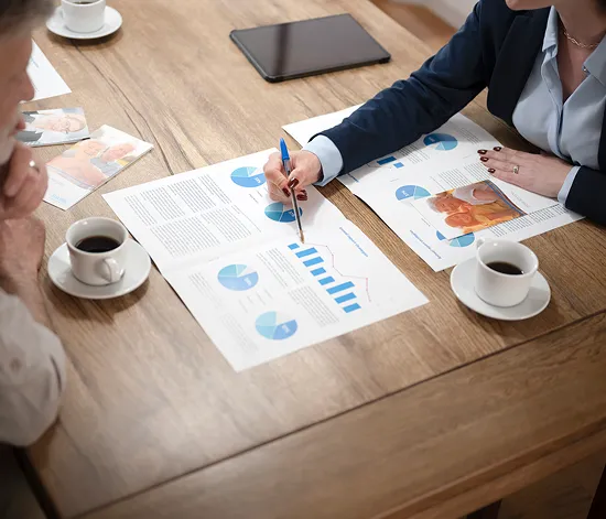 Business professionals reviewing financial reports and loan documentation with accounting support for bank loan applications