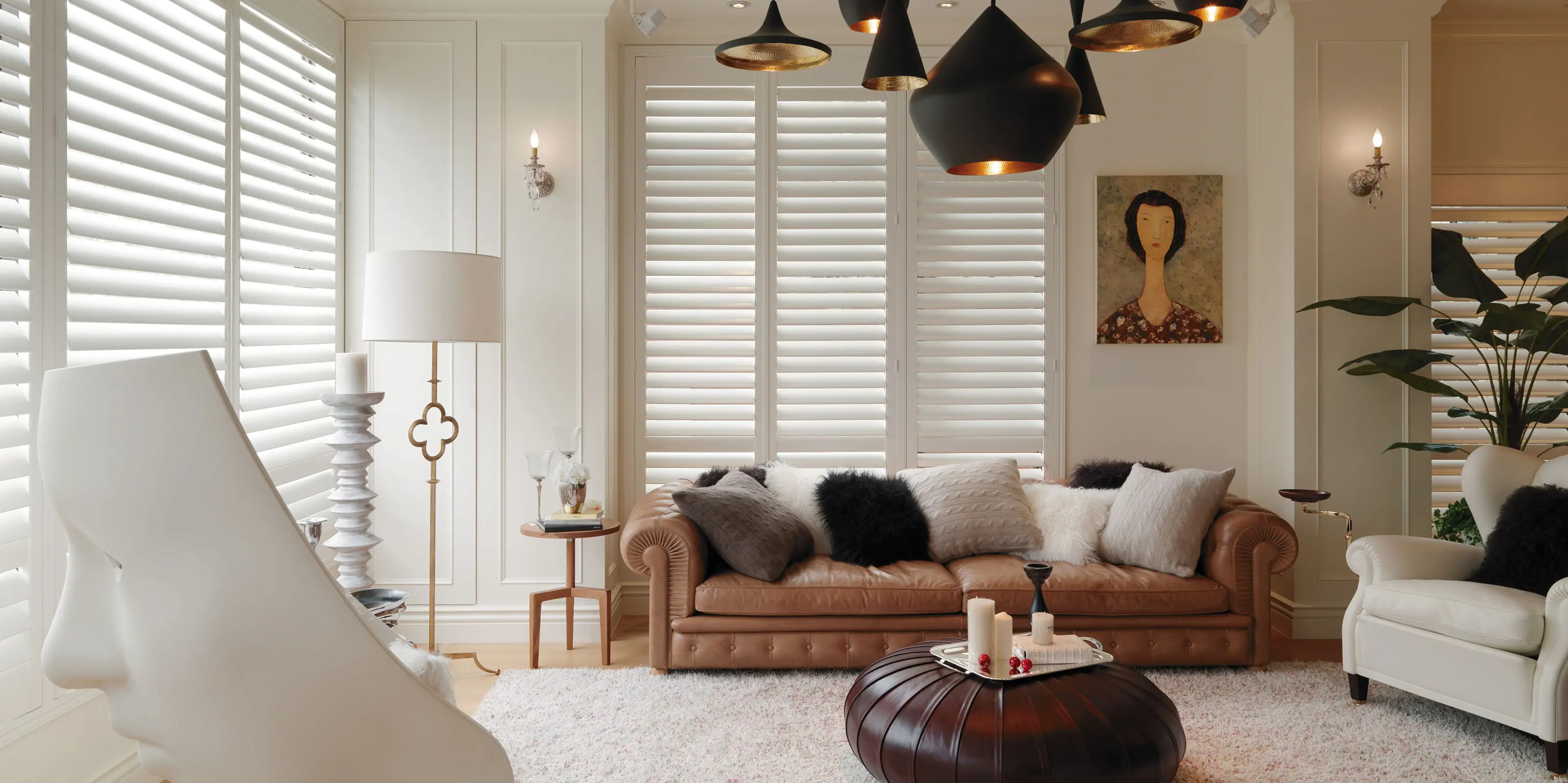 Elegant living room with plantation shutters and cozy sofa.