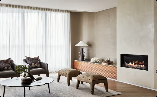 Cozy living room with custom curtains and modern fireplace.