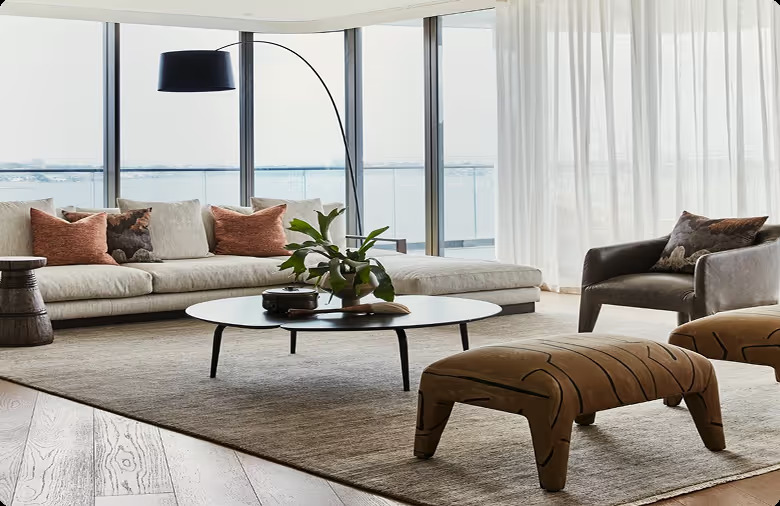 Modern living room with sofa, coffee table, and custom design curtains.