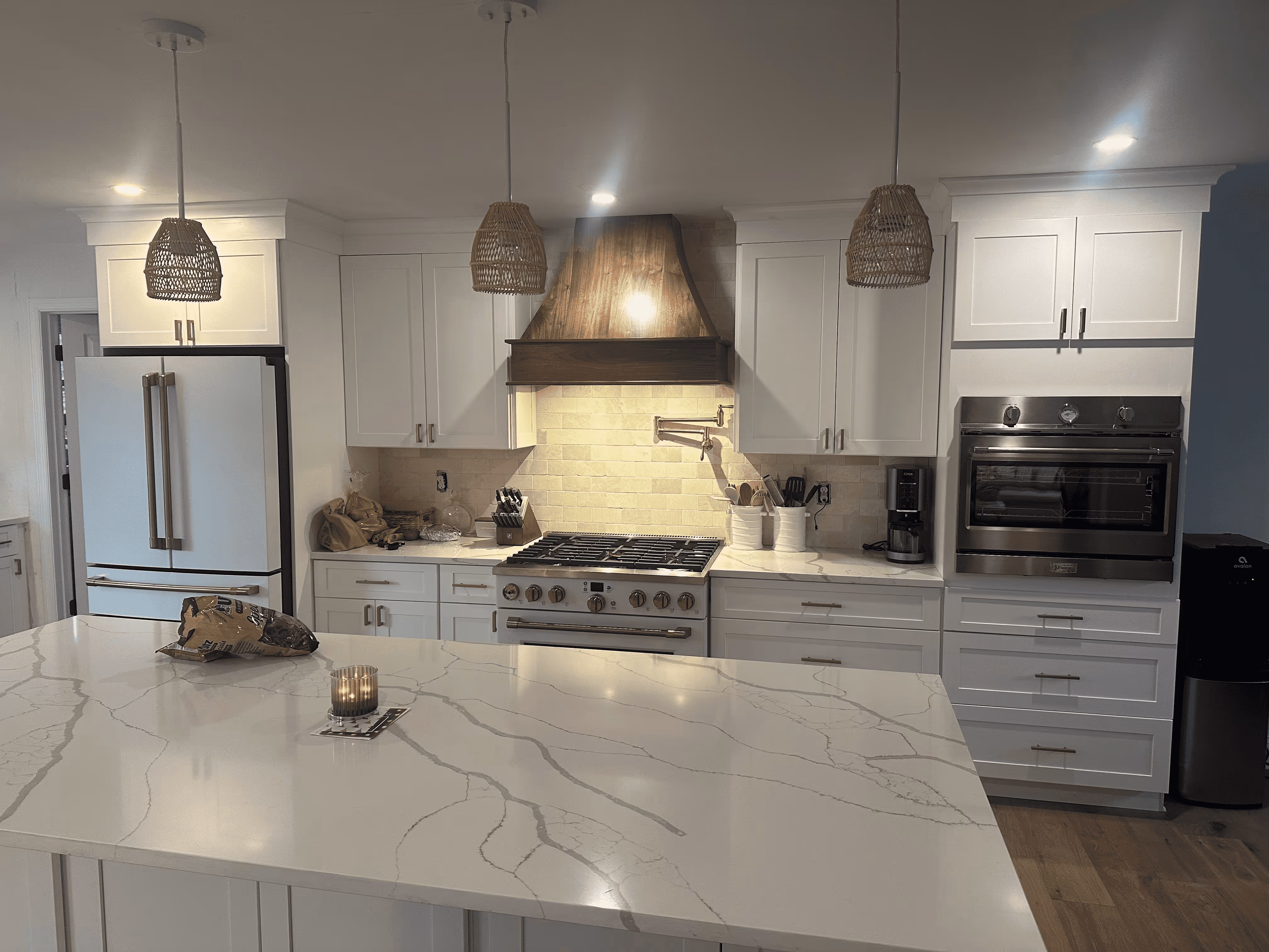 Modern kitchen renovation with white cabinetry, subway tile backsplash, and recessed lighting in a New Jersey home.