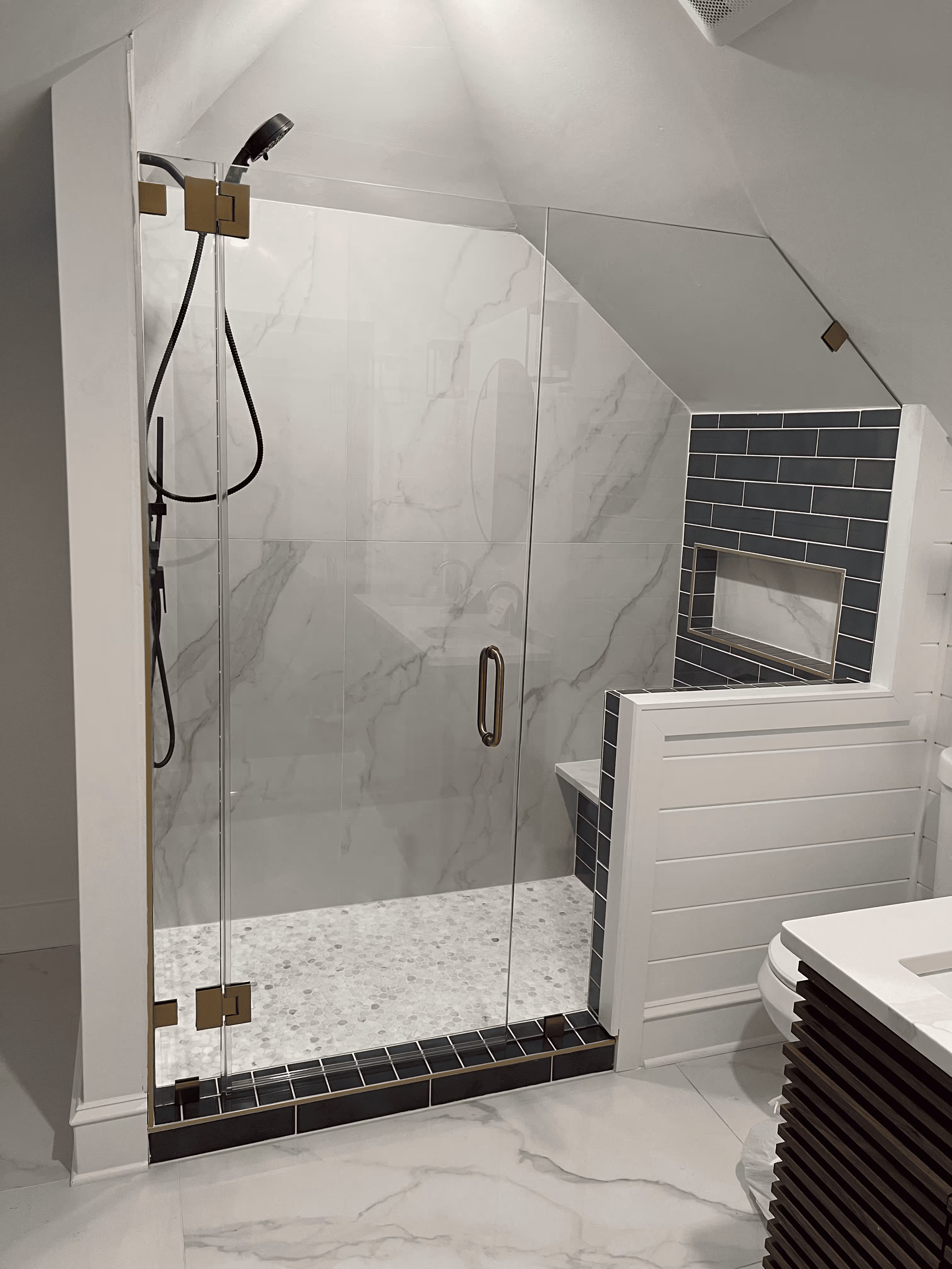 Modern New Jersey bathroom remodel with walk-in glass shower, custom vanity, and tile flooring.