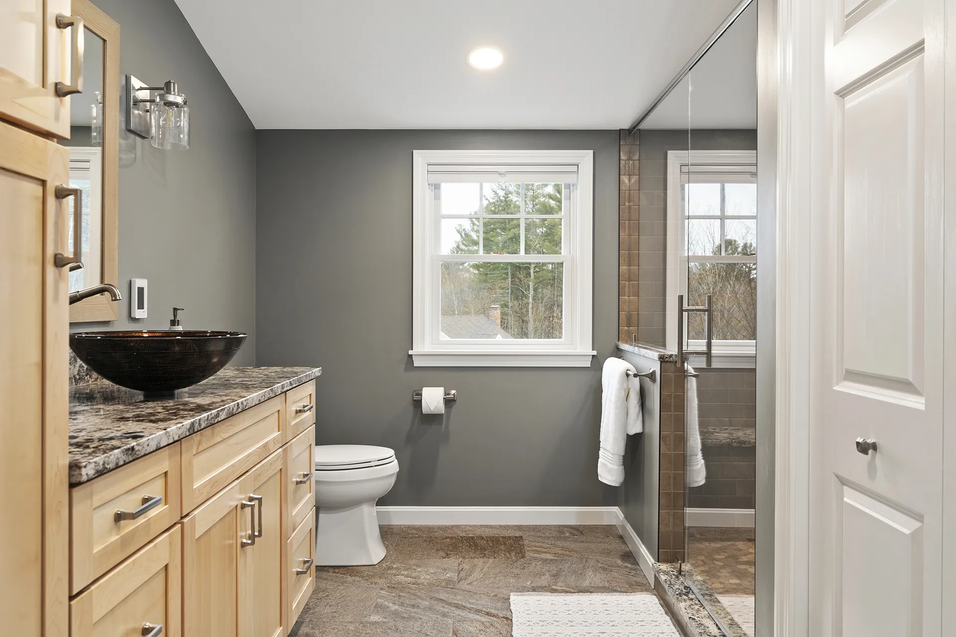 Primary bathroom remodel in Pelham, NH — spa-style walk-in shower with frameless glass by Oak Hill Design & Build