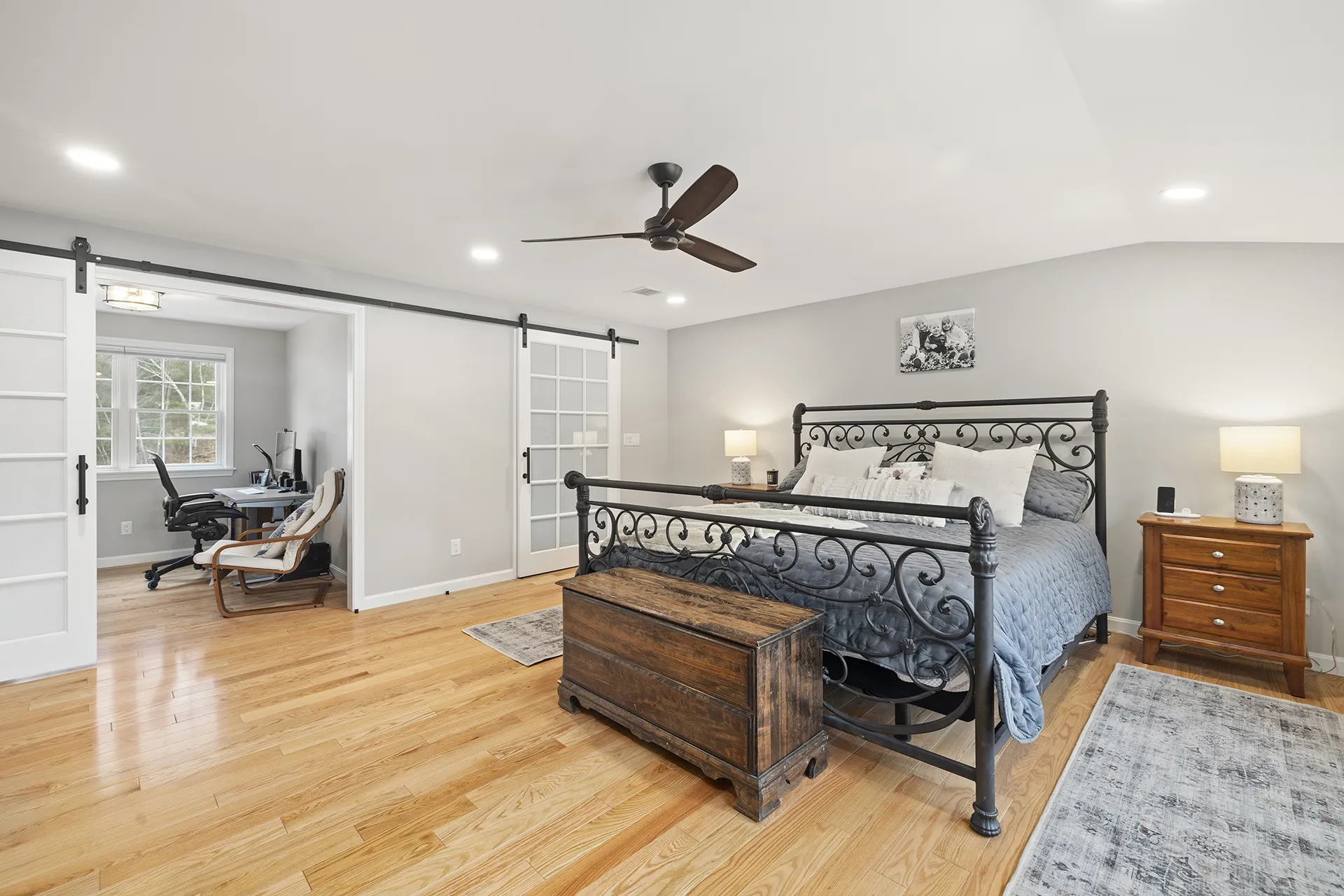Primary suite conversion in Pelham, NH — sleeping area with recessed lighting