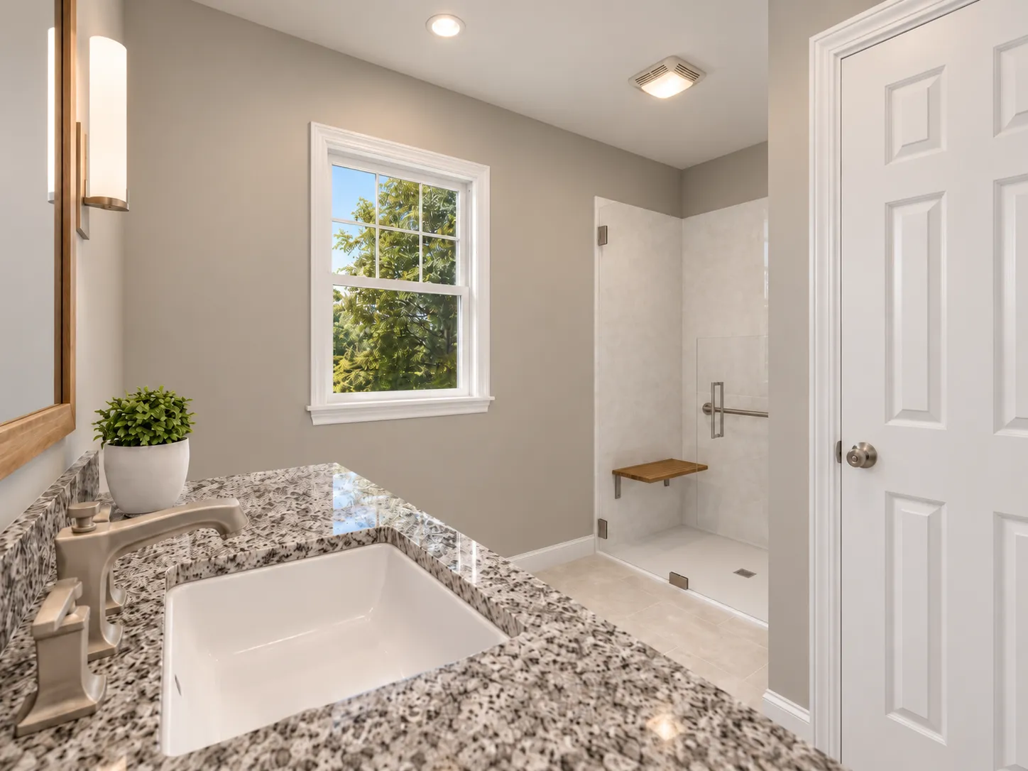 In-law suite bathroom in Pelham, NH — granite vanity and a curbless walk-in shower with bench and grab bar, designed for aging in place