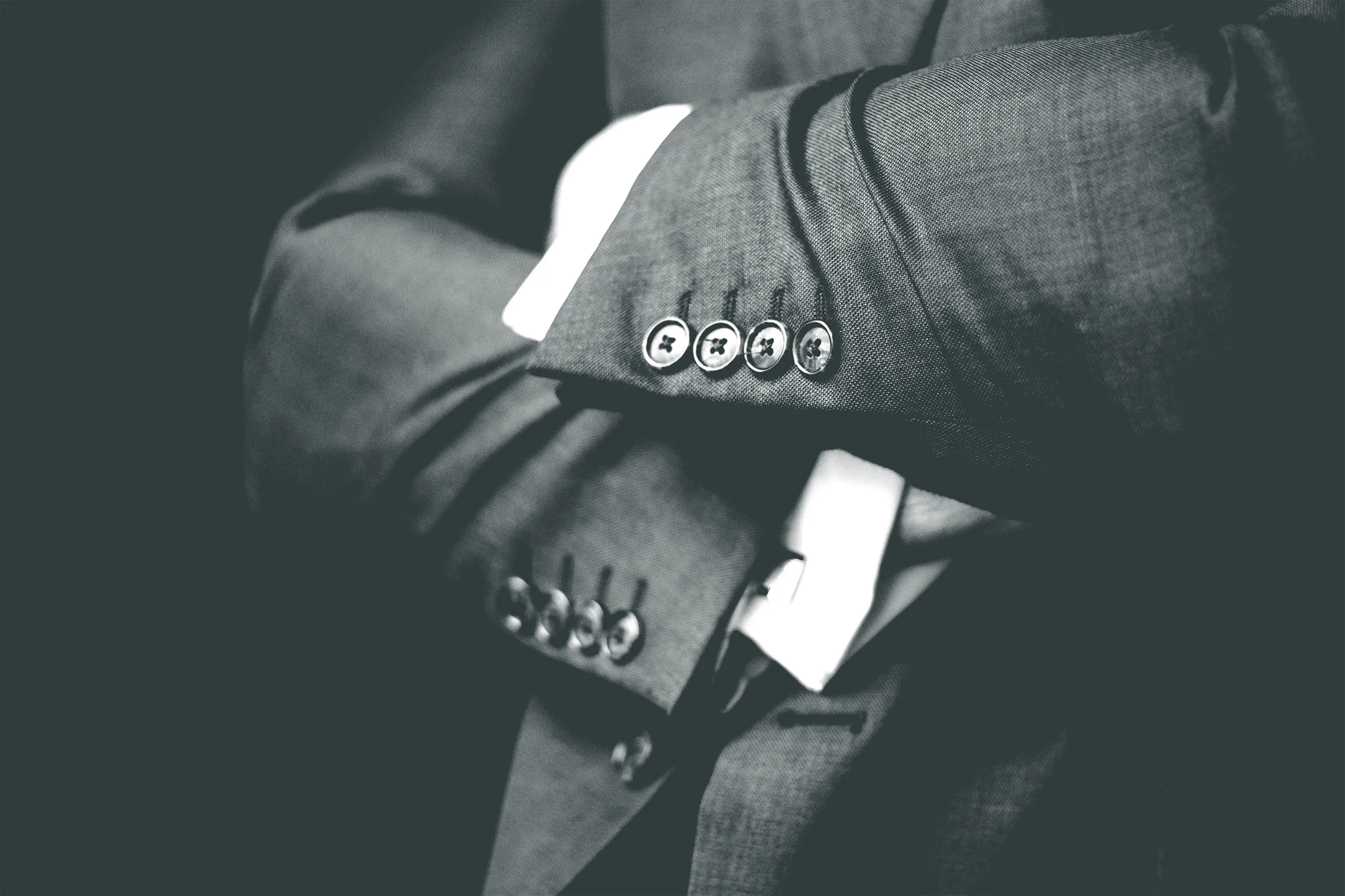 A lawyer in a suit with arms crossed