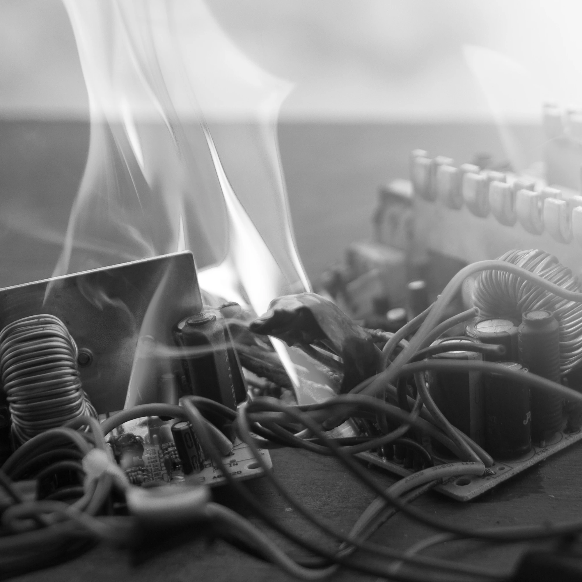 Burned electronic circuit board with smoke and flames