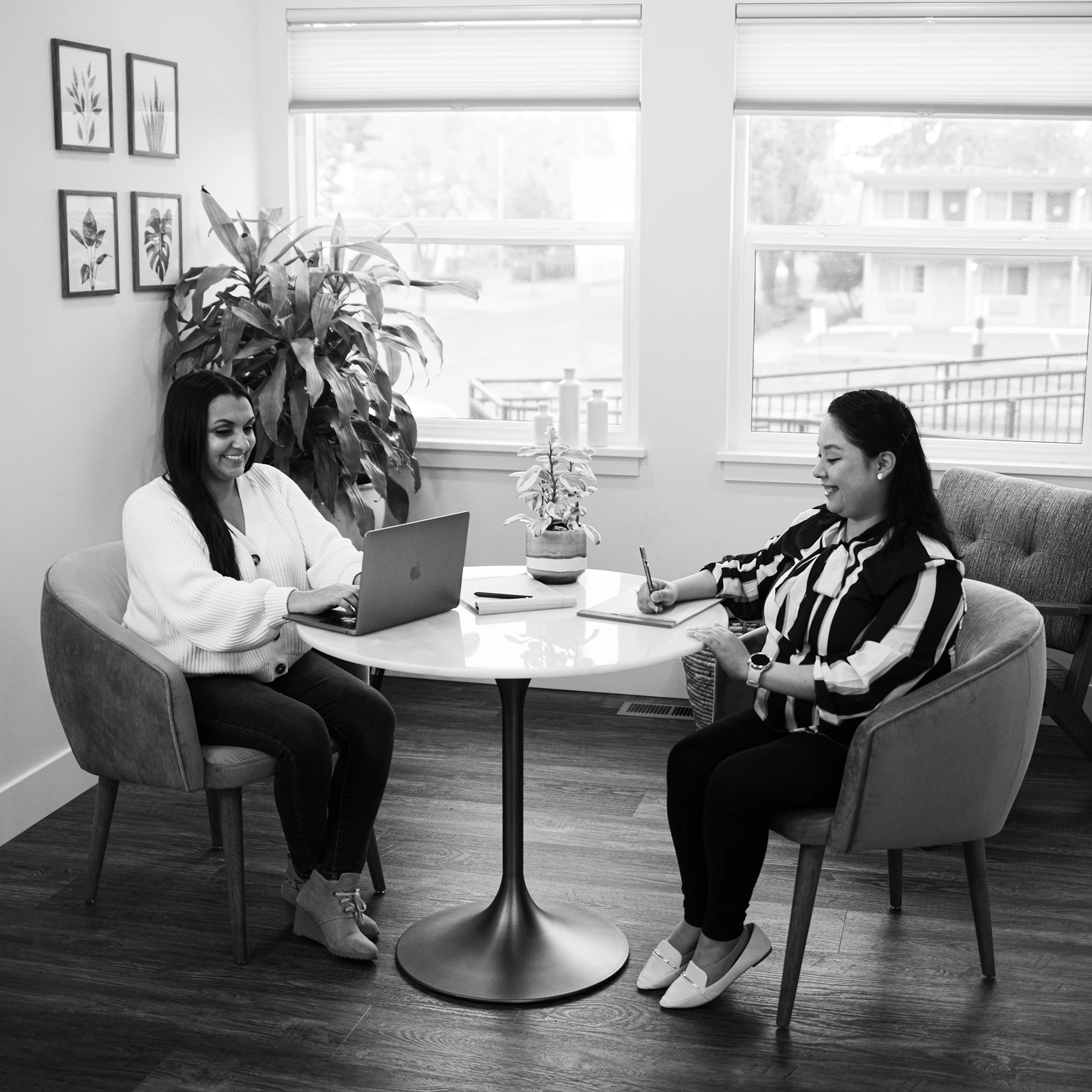 A Larwick Law employee talking with a client at a desk