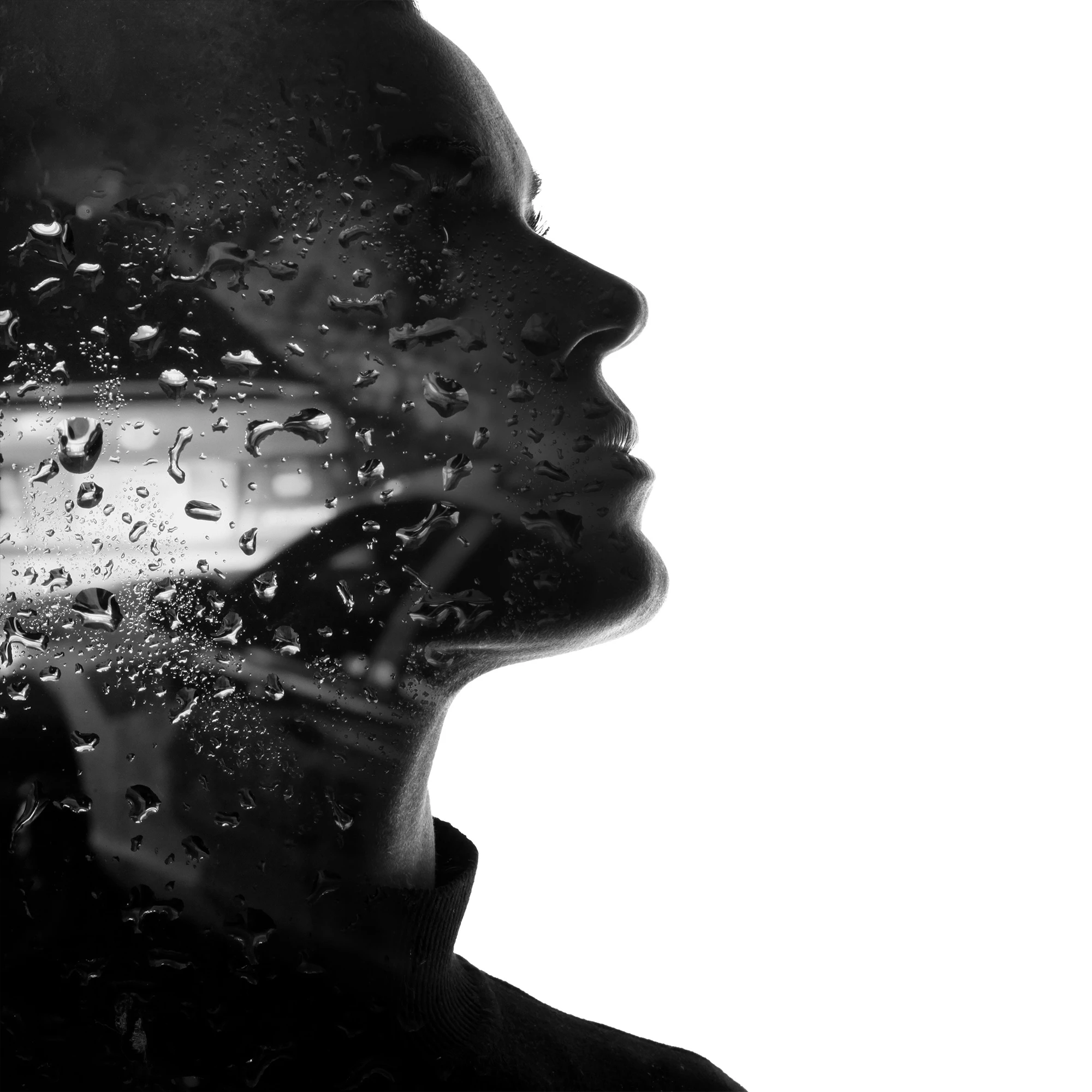 Silhouette face double exposure with raindrops on glass