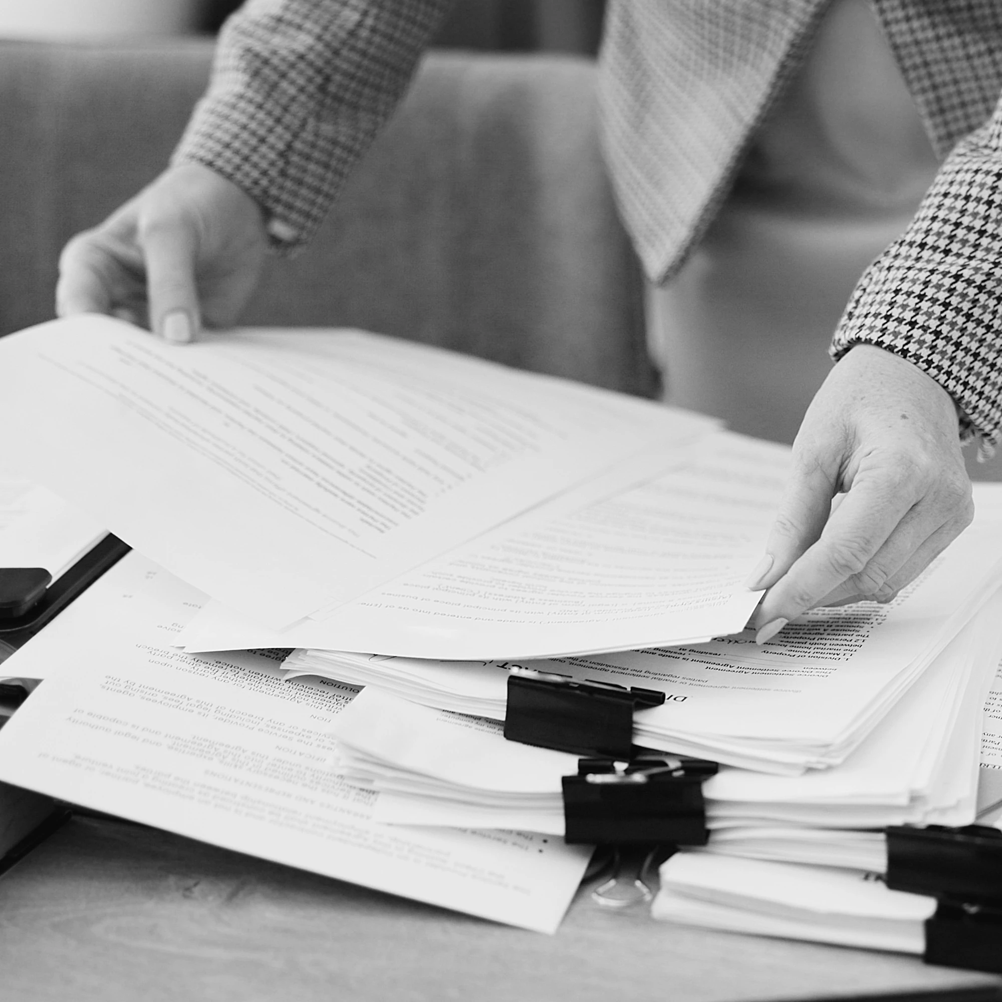 Lawyer sorting legal documents on an office desk