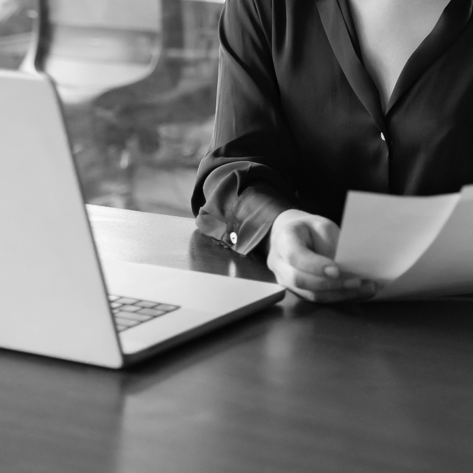 Female attorney with a laptop reviewing legal paperwork