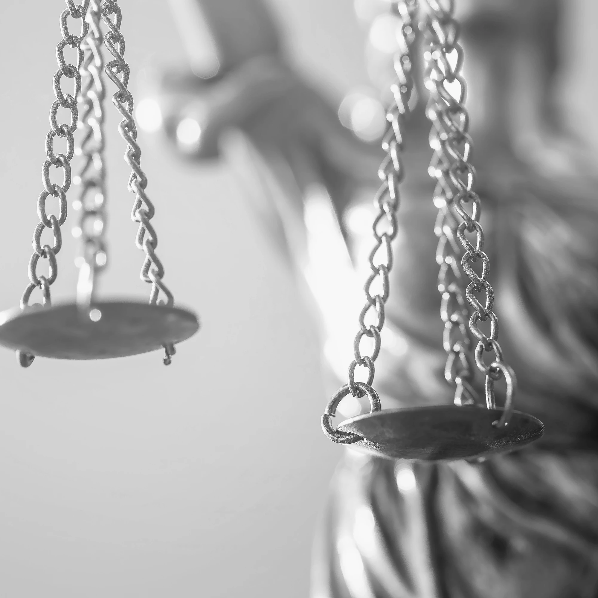 Close-up of silver justice scales symbolizing law