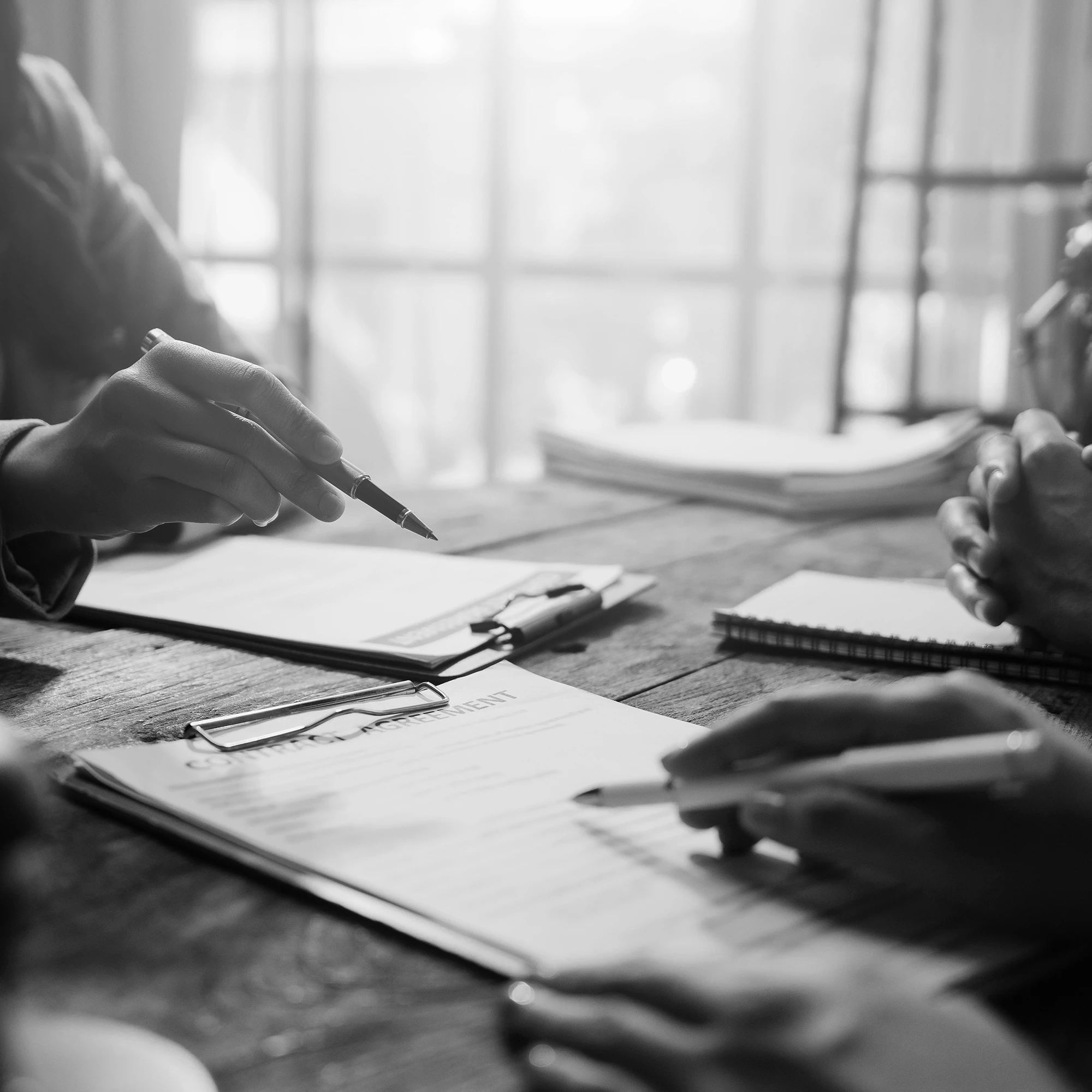 Lawyers reviewing and signing legal agreement papers