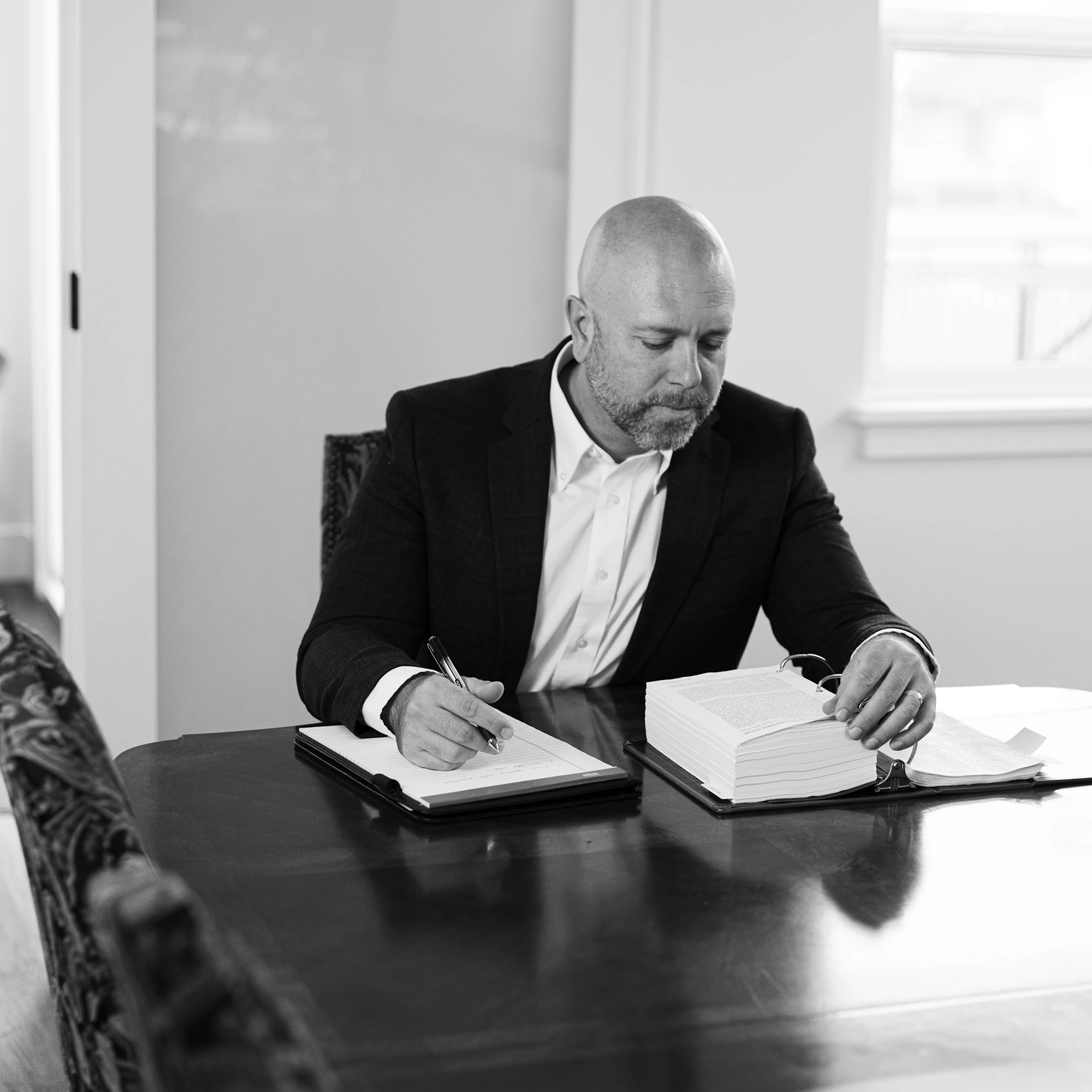 Derek Larwick reviewing legal documents