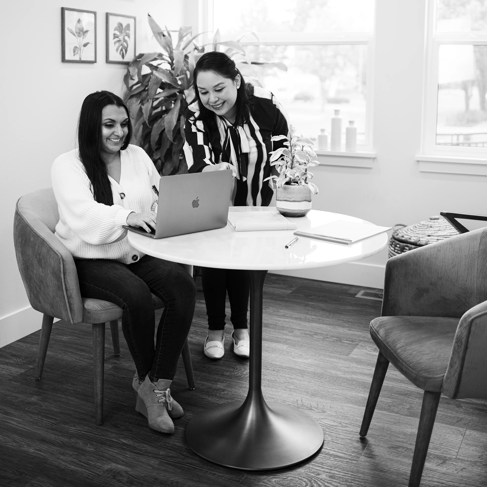 A Larwick Law employee reviewing items on a laptop with a client
