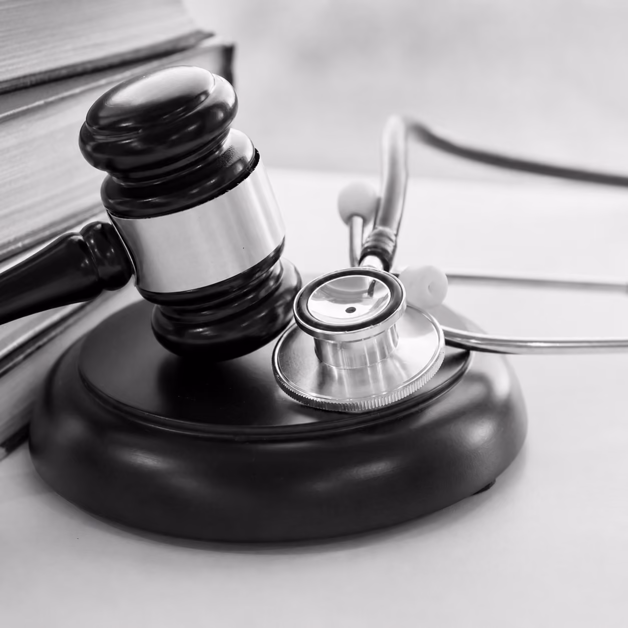 A black-and-white photo of a judge's gavel and a stethoscope