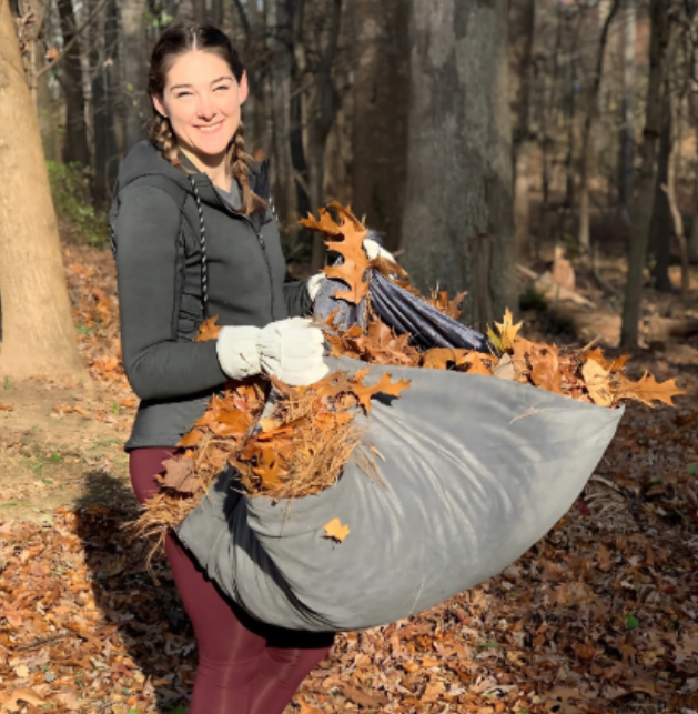 Volunteer girl clearing the yard.