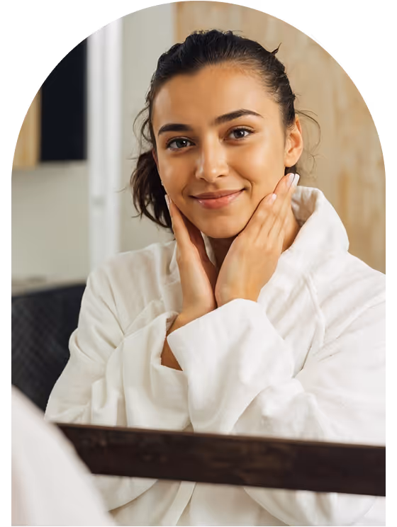 Happy woman looking in mirror