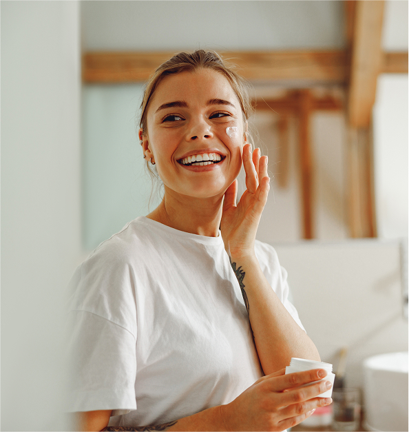 Happy woman doing skincare routine