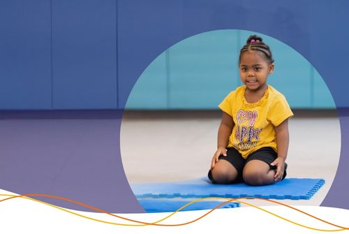 African American preschool child practices mindfulness on a yoga mat at school, she is calm and enjoying herself happy