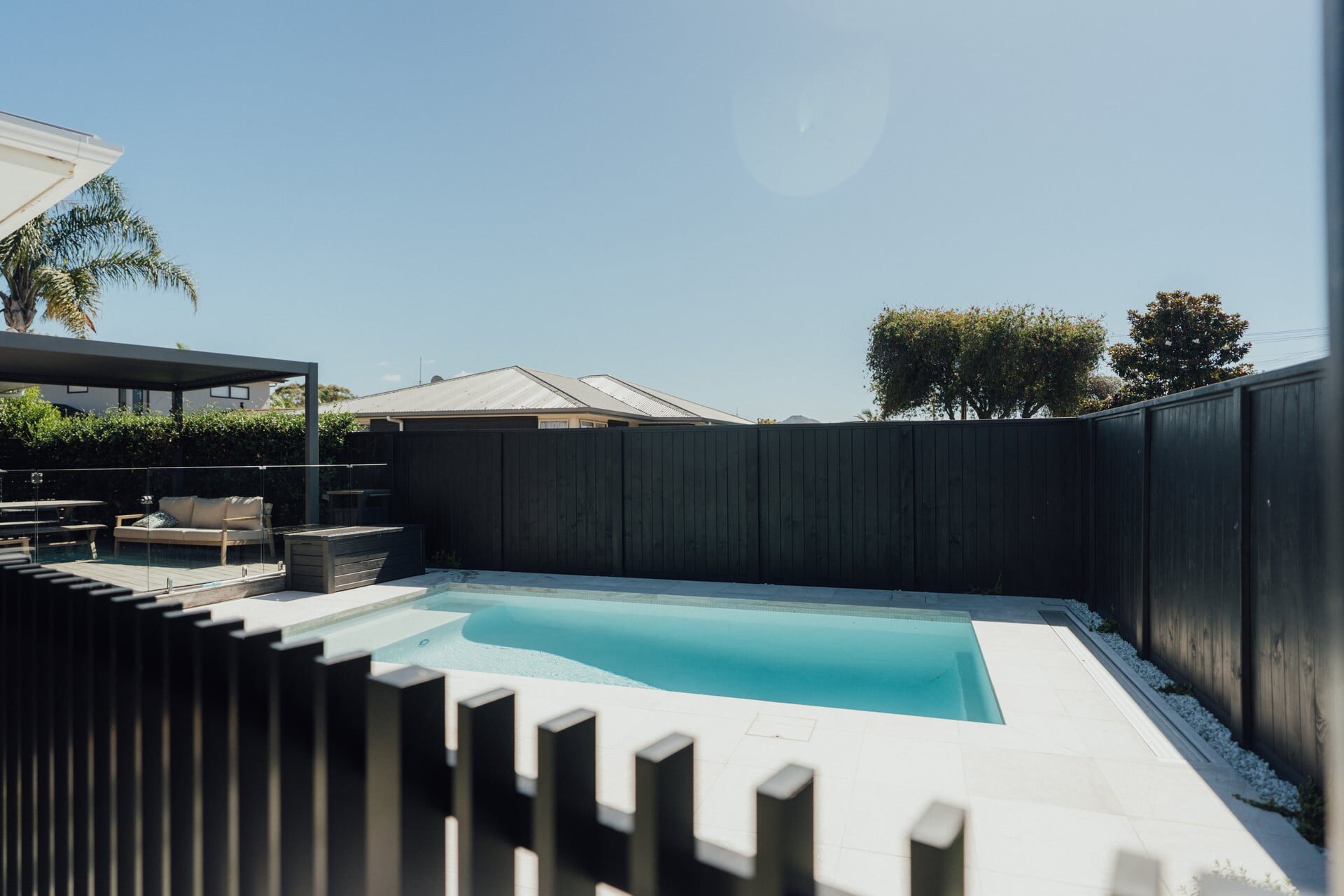 Modern house entrance with timber cladding brick detailing and olive tree garden pathway at Marine Parade project