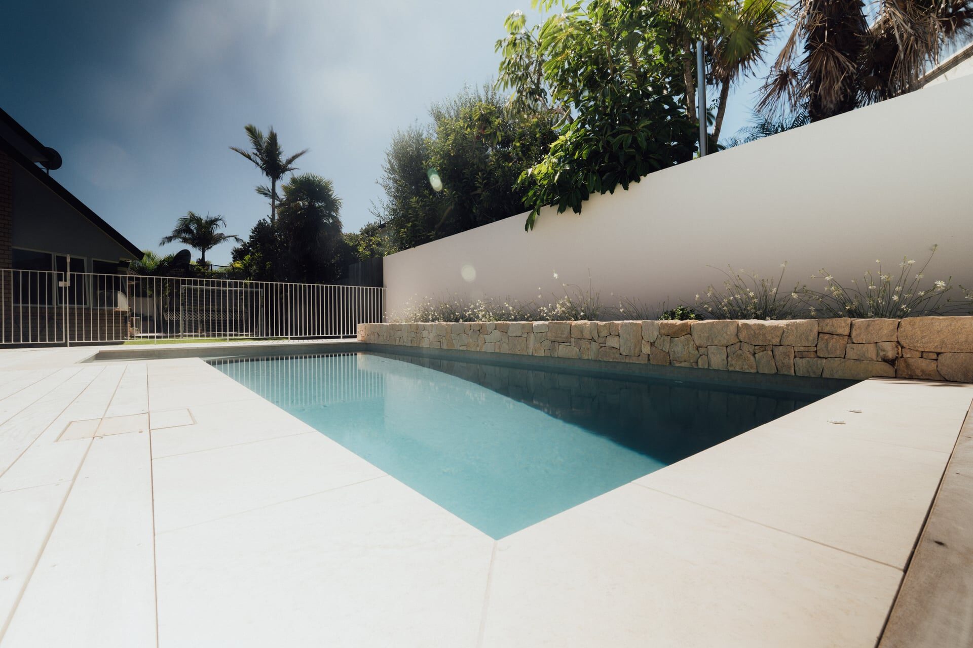 Timber deck with raised edging detail meeting manicured green lawn at Marine Parade landscaping project