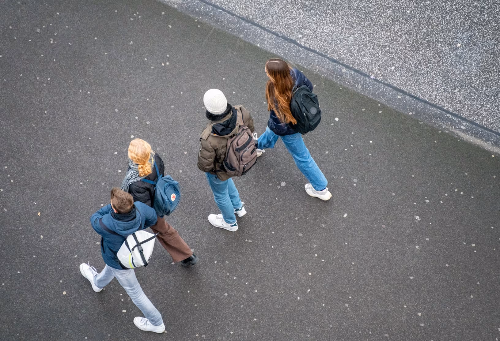 Photo of young people walking down a street shot from above