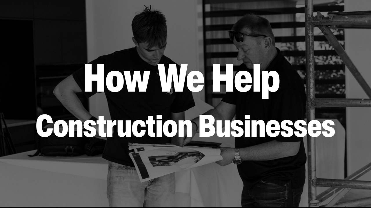Two men reviewing construction plans indoors next to scaffolding, with text overlay 'How We Help Construction Businesses'.